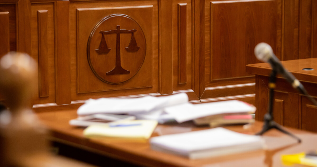 Courtroom interior with scales of justice in focus