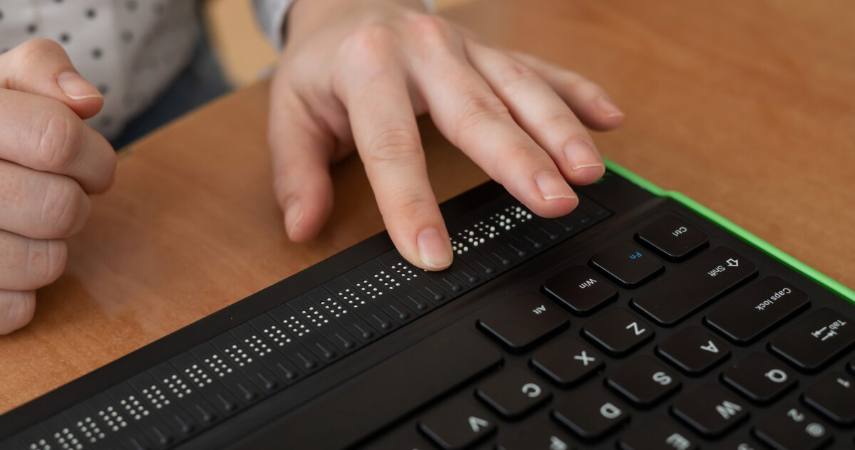 Hands using a braille keyboard