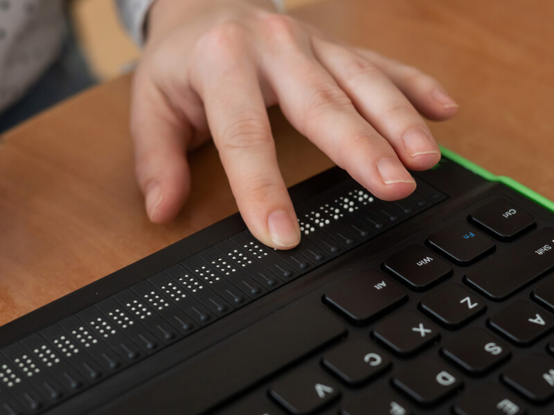 Hands using a braille keyboard