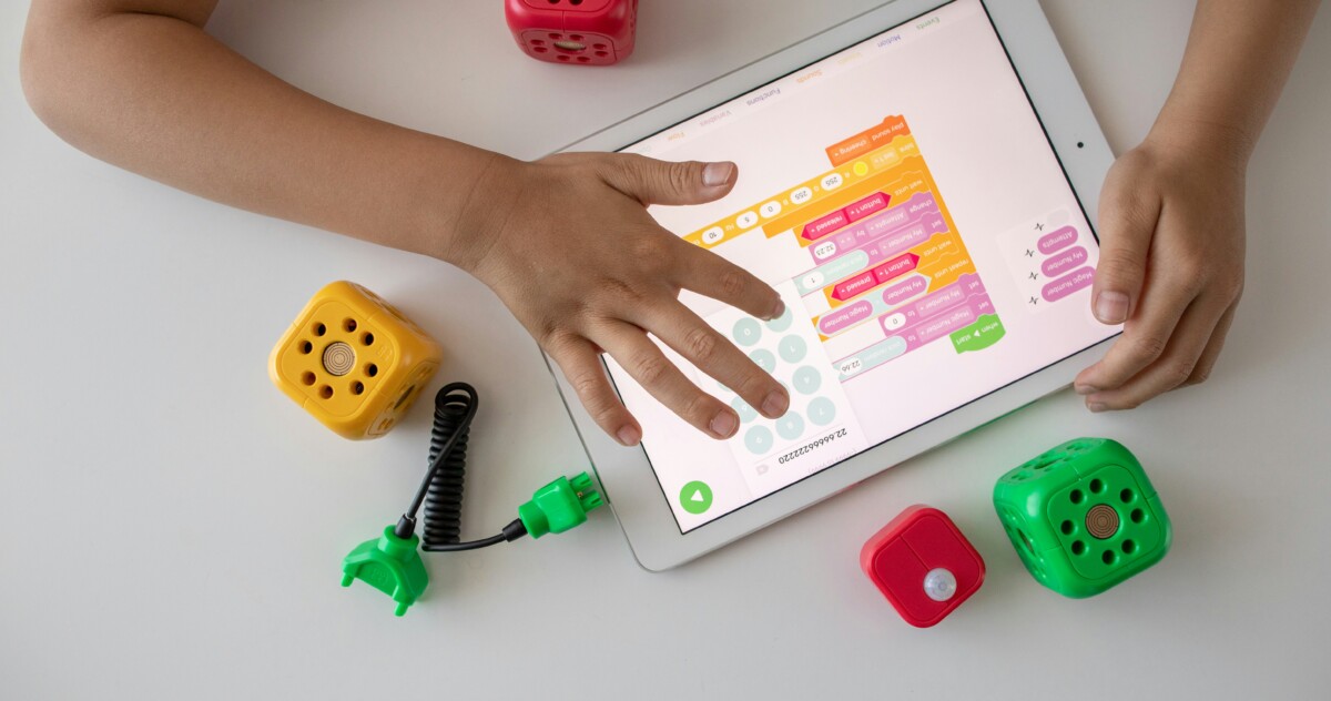 Child Playing With Tablet and Toys